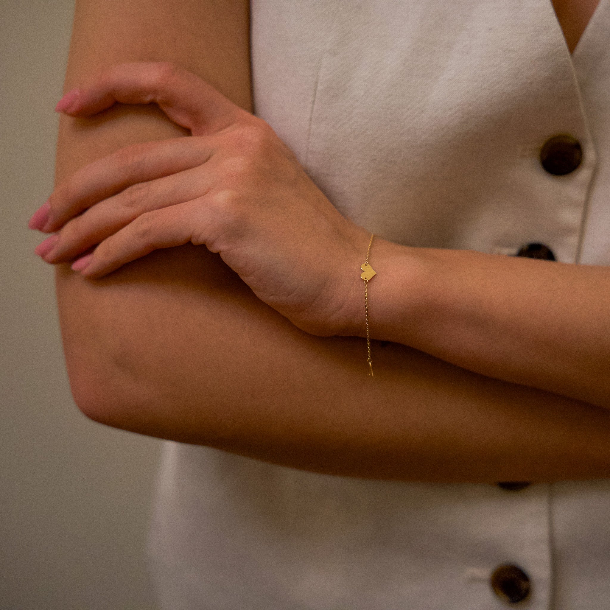 gold heart bracelet on model