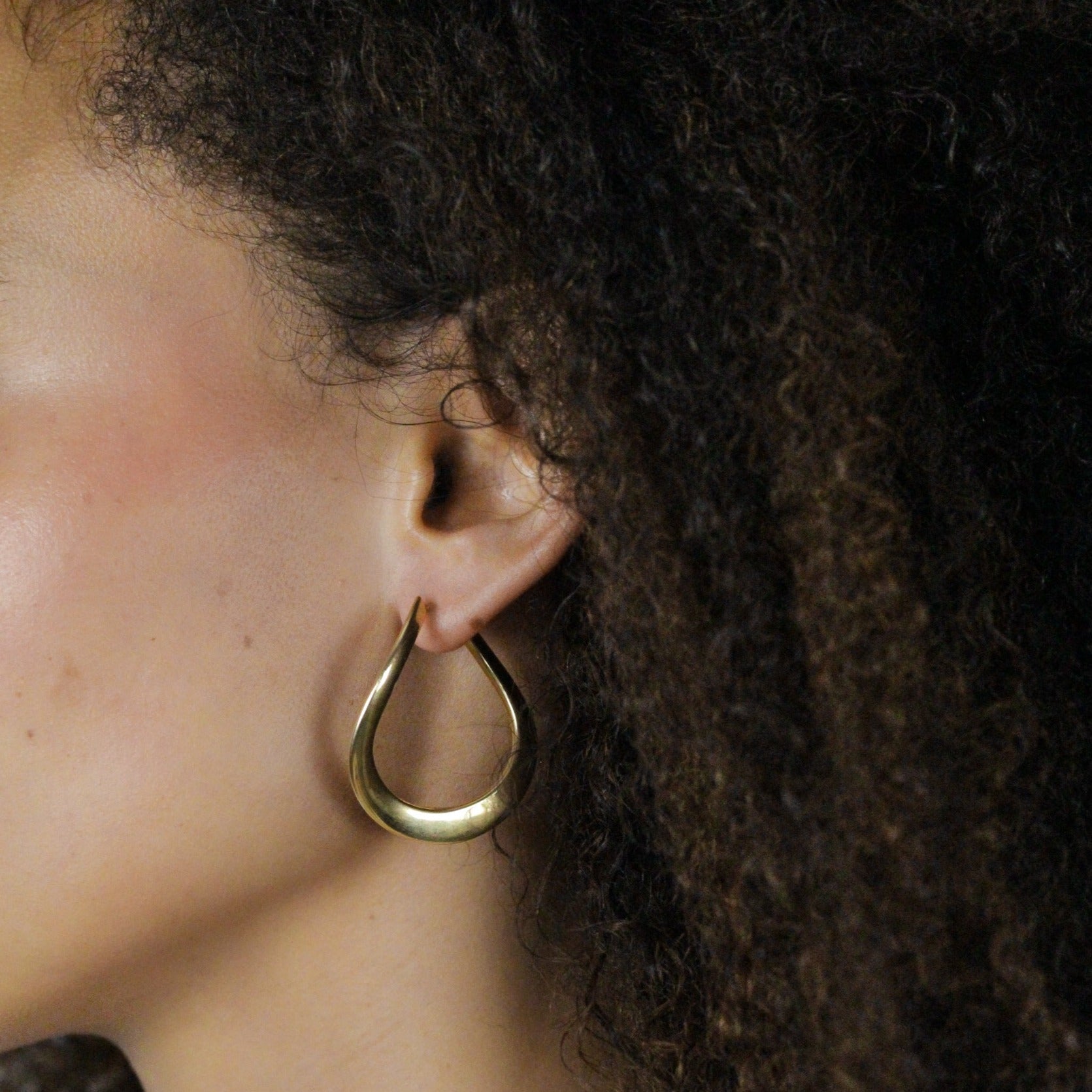 Sculptural gold earrings, women on model