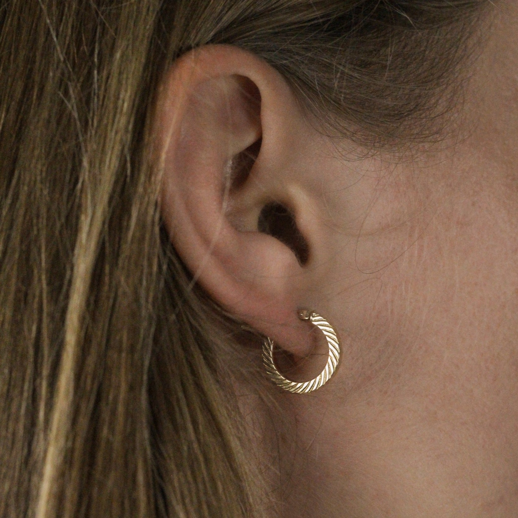 Classic gold hoops earrings side on model