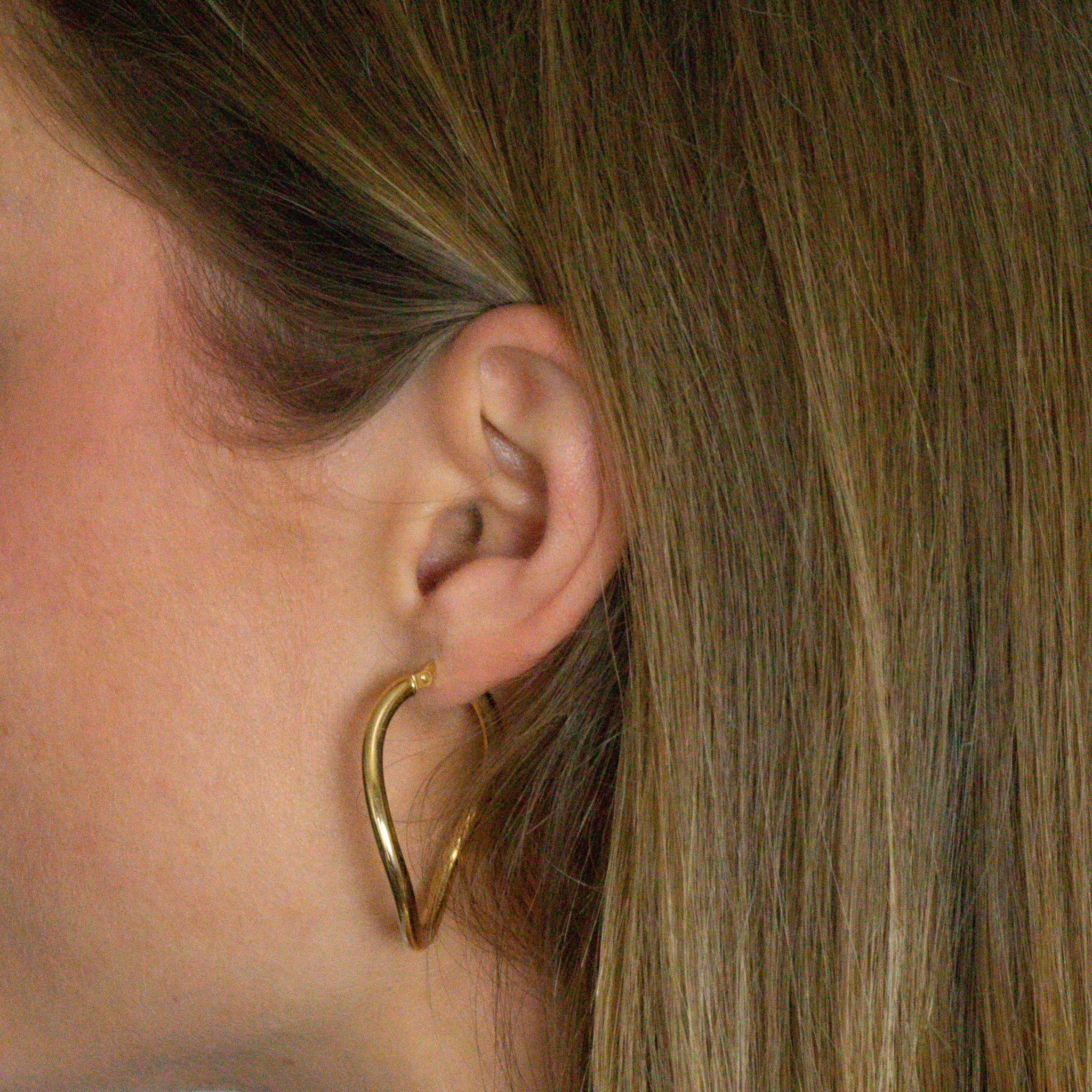 Gold hoop earring on model