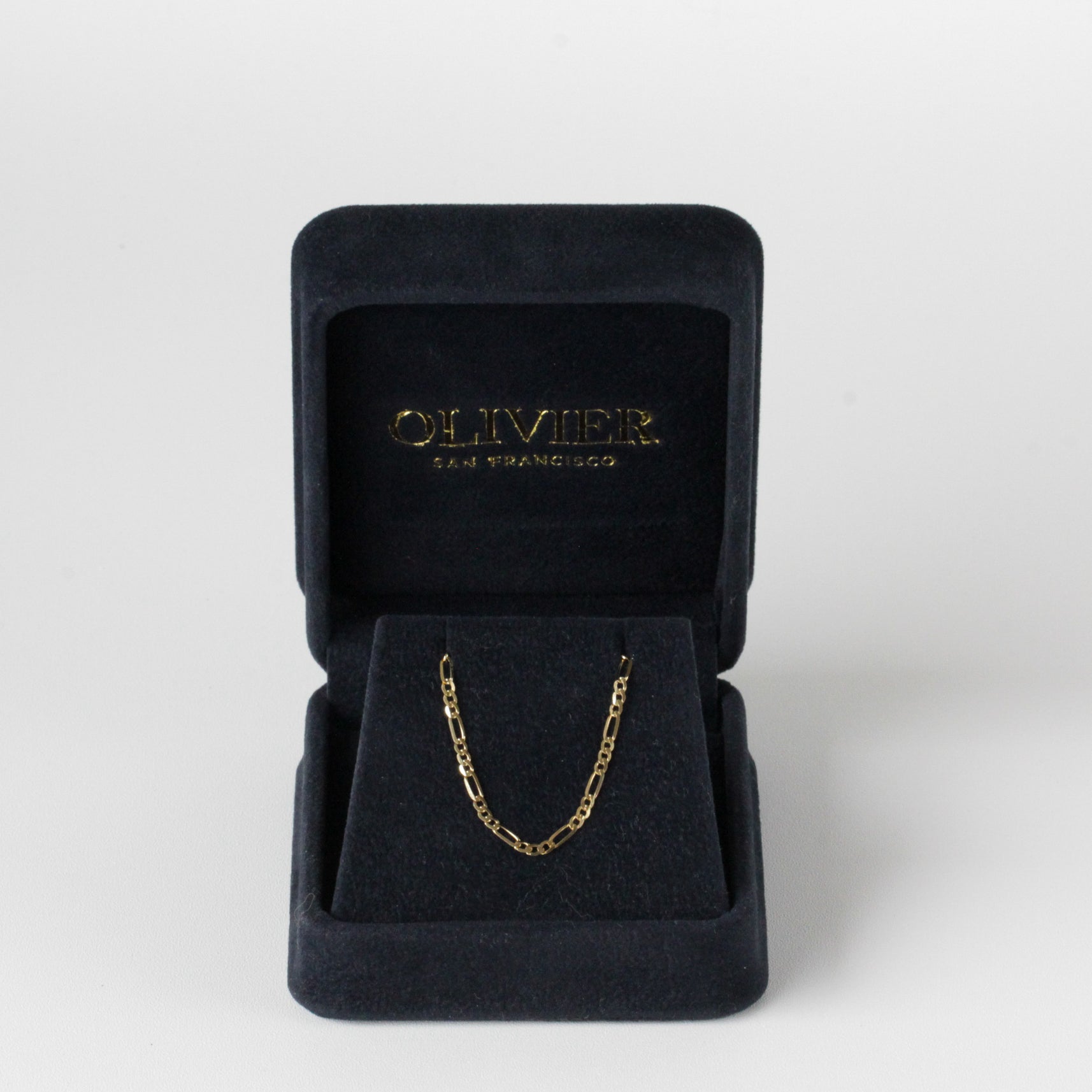 gold figaro chain in box