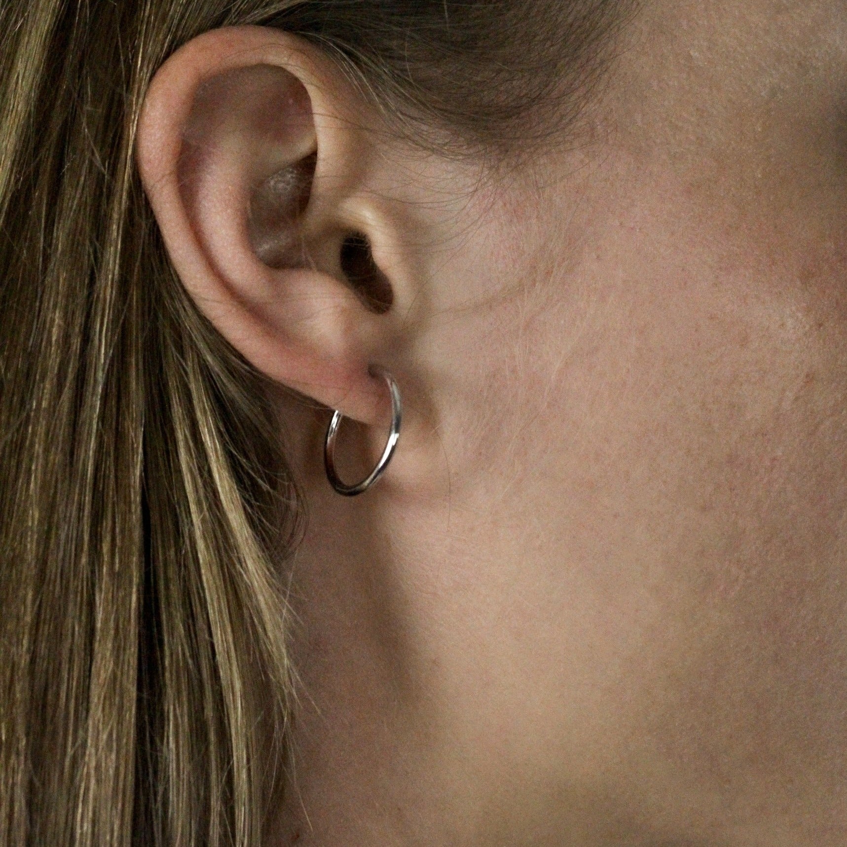 small white gold hoops earrings on model