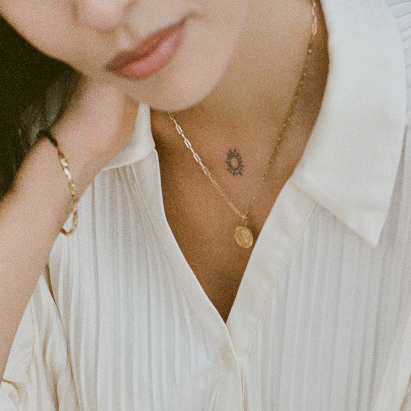 Gold Jewelry on model wearing white