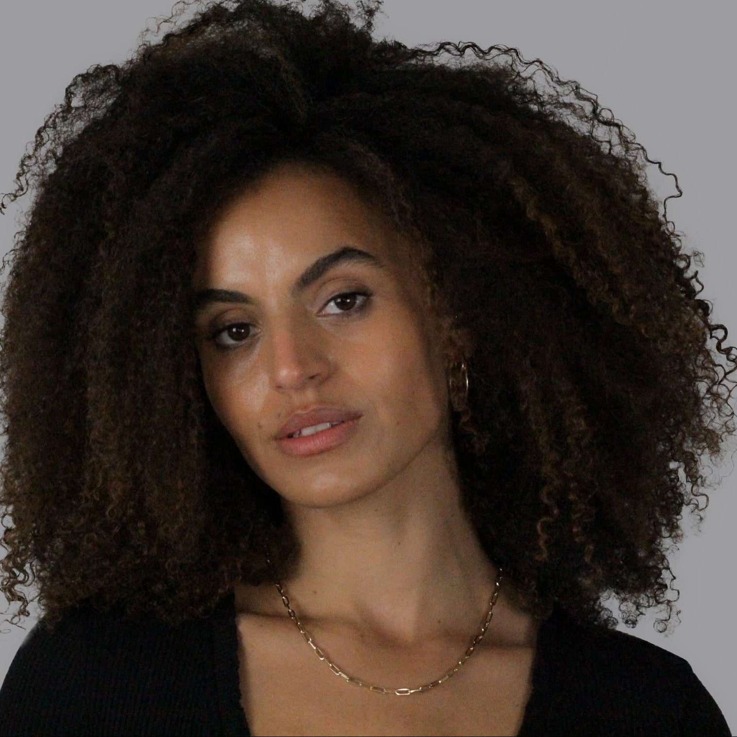 Woman with curly hair against a white background