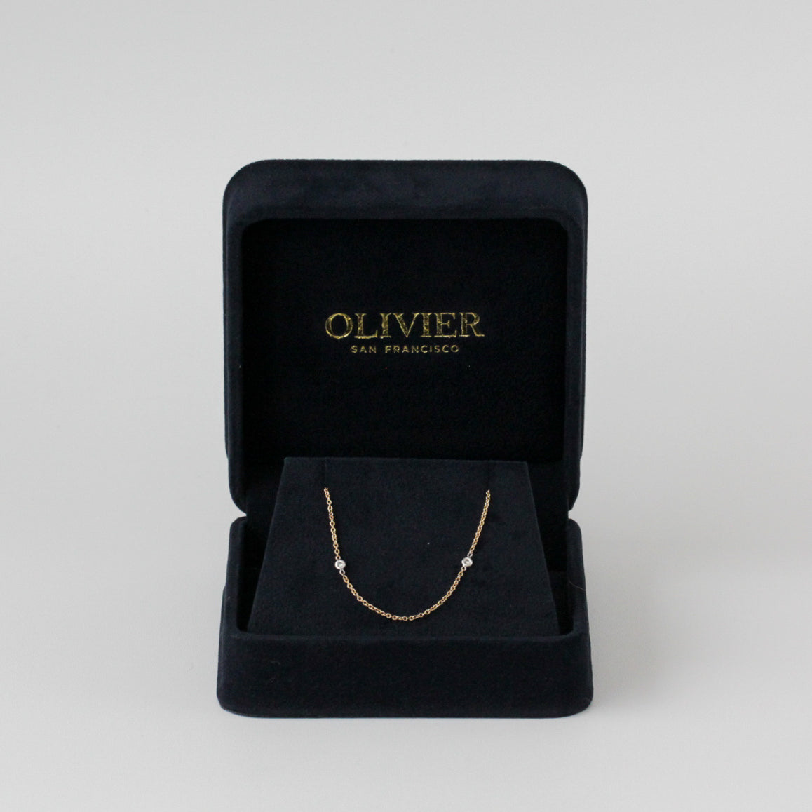 gold necklace with diamonds in box